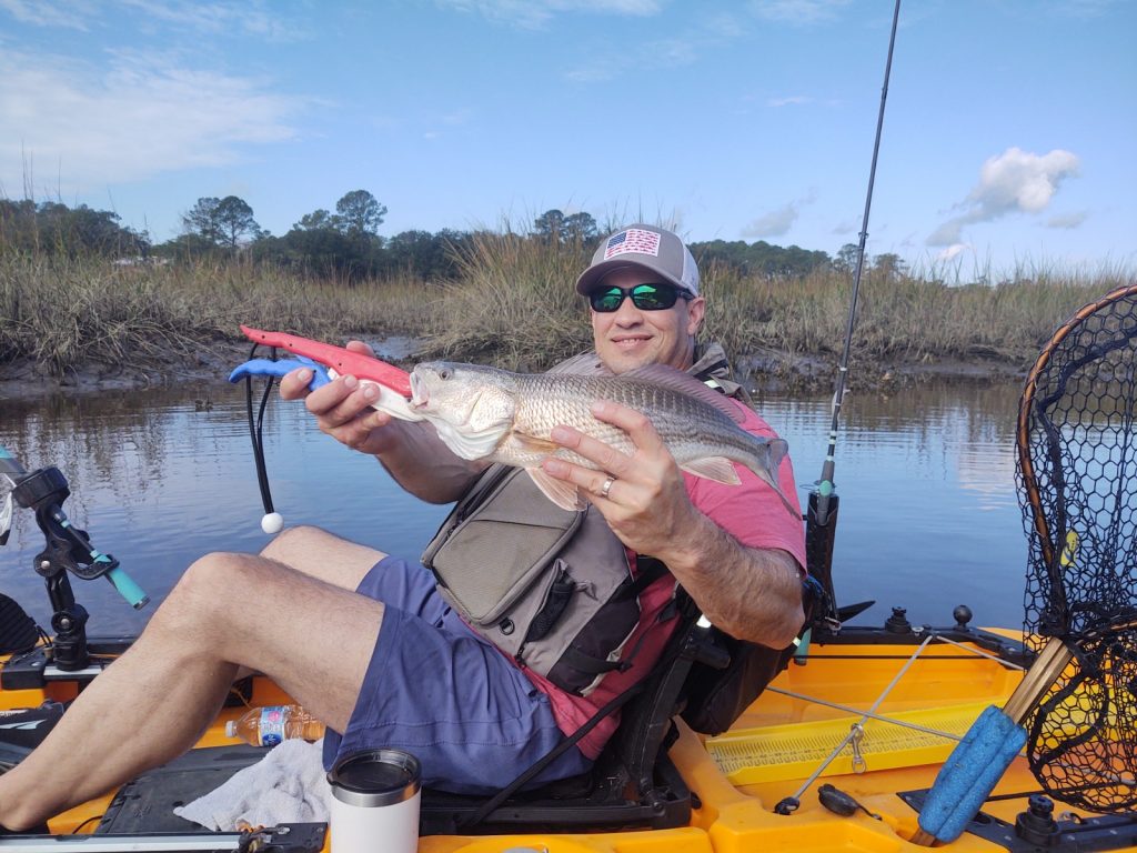 Kayak angler with redfish