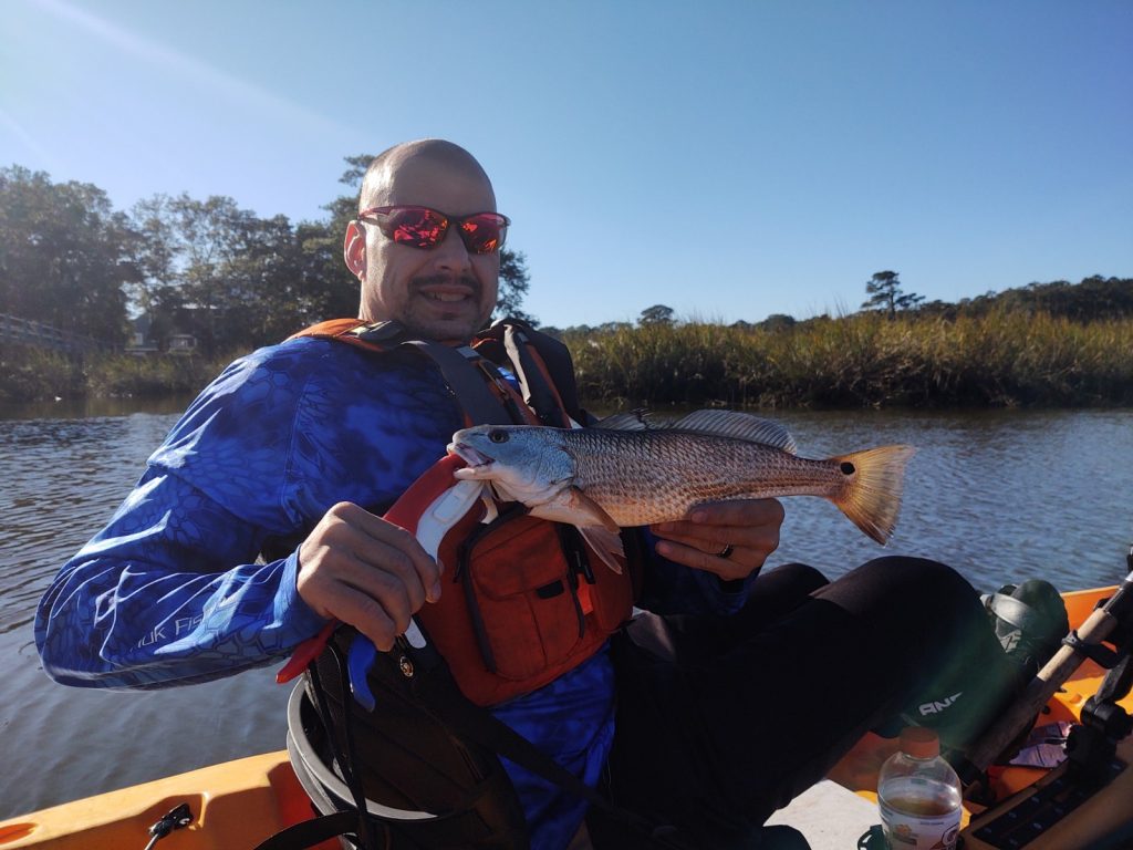 Kayak angler with redfish