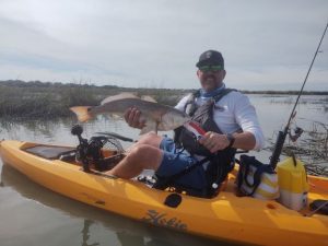 kayak angler with redfish